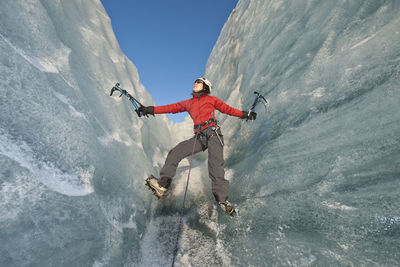 Woman climbing on the fjallsjökull glacier in iceland