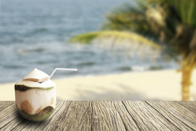 Close-up of coffee on beach