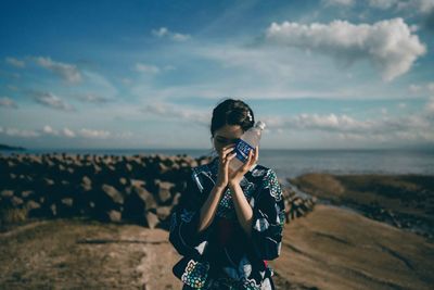 Man photographing against sky