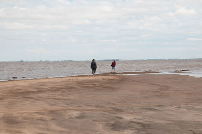 Couple walking by the sea