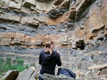 Full length of woman standing on rock