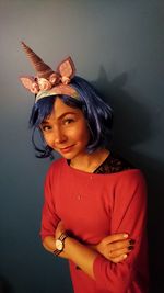 Portrait of woman wearing headband against wall