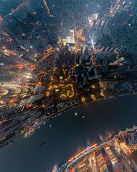 Aerial view of illuminated buildings in city at night