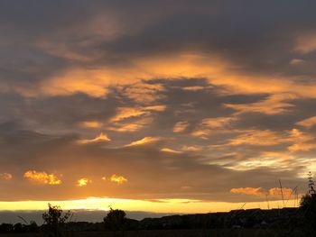 Low angle view of dramatic sky during sunset