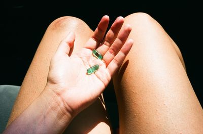 Close-up of woman hand over black background