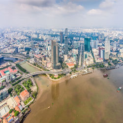 High angle view of cityscape by sea against sky