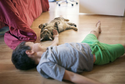 Cat lying on hardwood floor