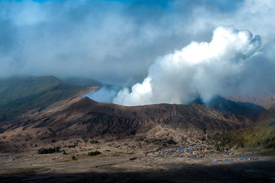 Smoke emitting from volcanic mountain against sky