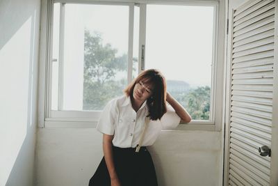 Woman looking through window