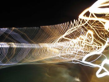 Low angle view of illuminated lights against sky