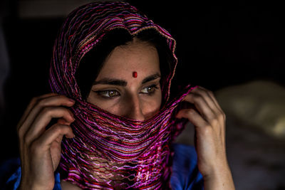 Close-up of young woman wearing scarf