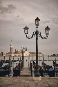 Street light on wooden post in canal