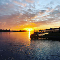 Scenic view of river against sky during sunset