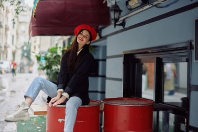 Portrait of young woman standing in city