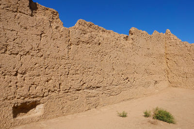 Panoramic view of desert against clear blue sky
