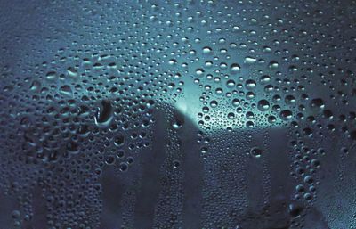 Full frame shot of raindrops on glass window