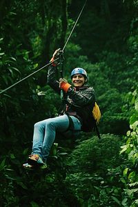 Full length of woman standing in forest