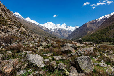 Scenic view of mountains against blue sky