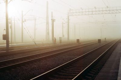 Railroad tracks against sky during foggy weather