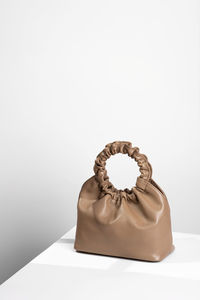 Handbag on a minimalistic white background.conceptual modern still life, copy space, negative space.