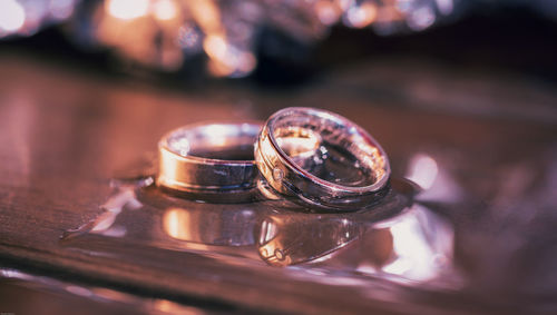 Close-up of wet wedding rings on table