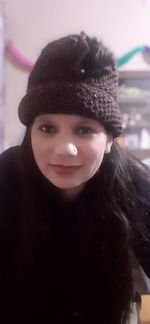 Portrait of smiling young woman wearing hat