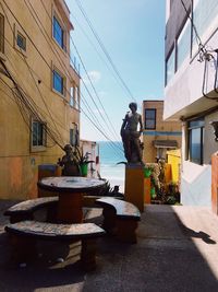 People working on building against sky in city