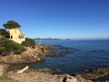 Scenic view of sea against clear blue sky