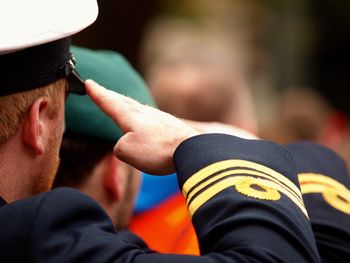 Close-up of police man saluting outdoors