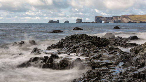 View of seascape against cloudy sky