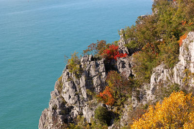 High angle view of rocks by sea against sky