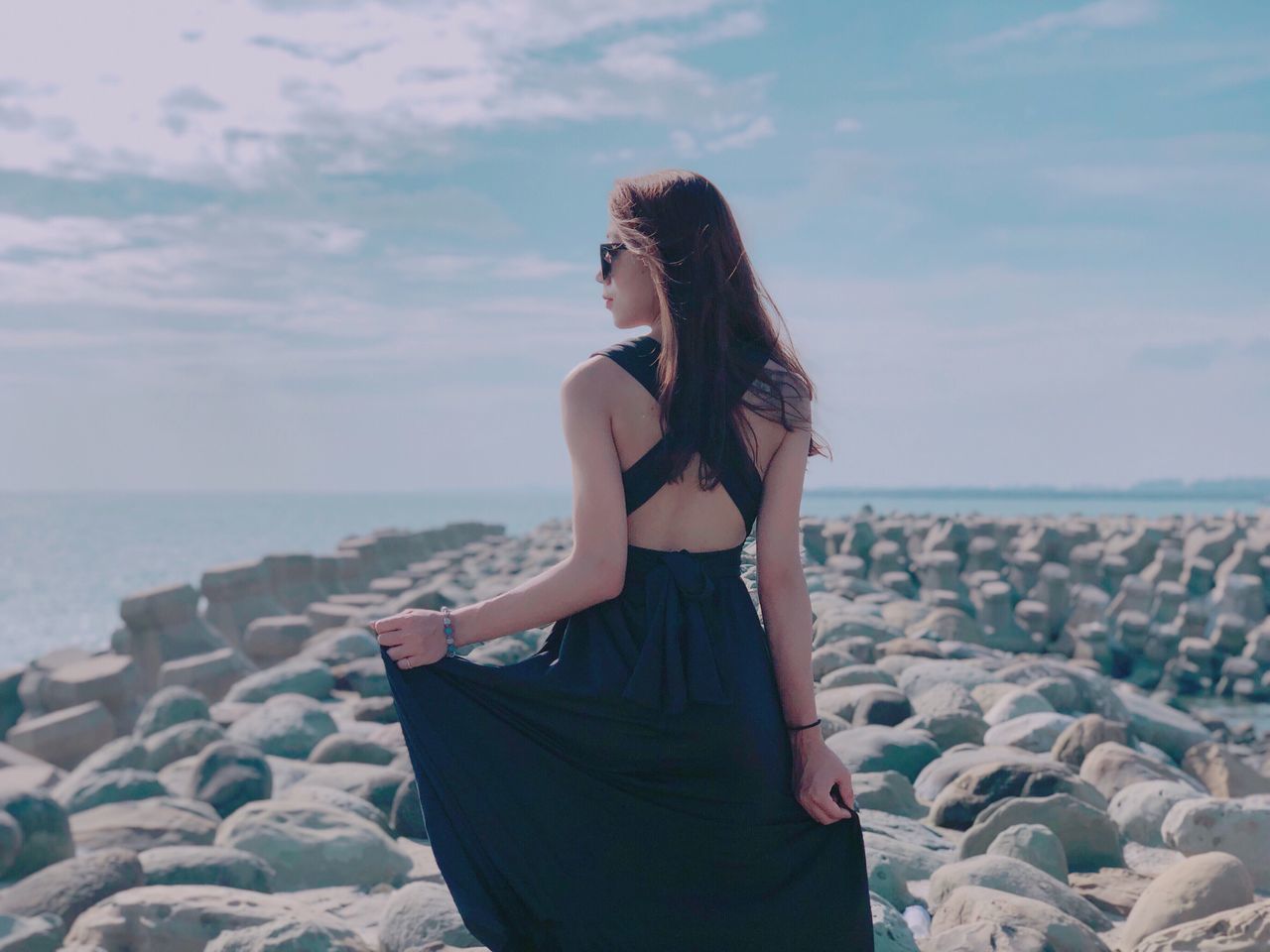 WOMAN STANDING AT BEACH