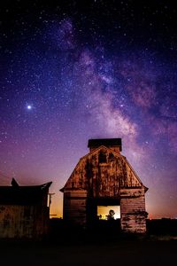 Low angle view of buildings against sky at night