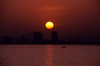 Scenic view of sea against orange sky