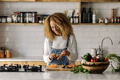 Woman preparing food in kitchen at home