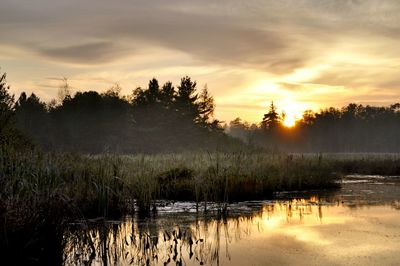 Scenic view of lake against sky during sunset