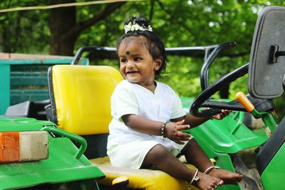 Portrait of smiling boy sitting in tractor