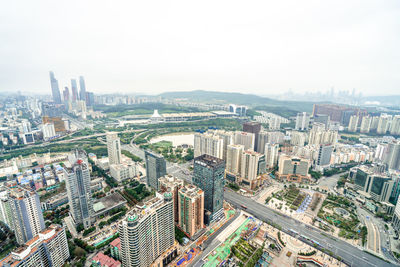 High angle view of modern buildings in city against sky