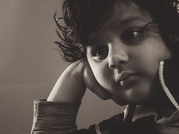 Close-up portrait of cute girl looking away