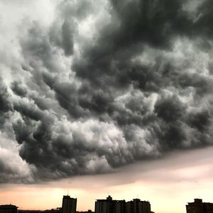 Low angle view of buildings against cloudy sky