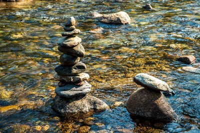 Balanced zen rock stacked stone art in flowing mountain stream