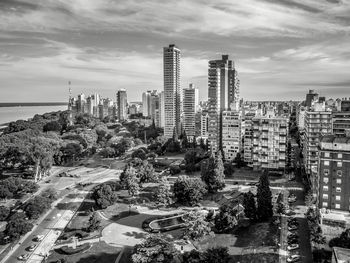 Buildings in city against cloudy sky