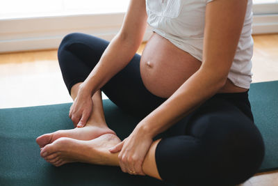 Midsection of woman sitting at home