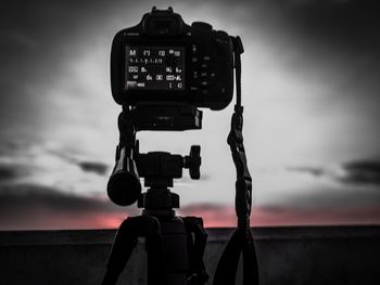 Close-up of camera against sky