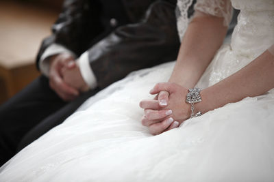 Midsection of bride holding hands