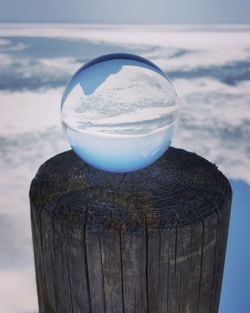 Close-up of ice on sea against sky