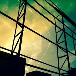 Low angle view of silhouette electricity pylon against sky