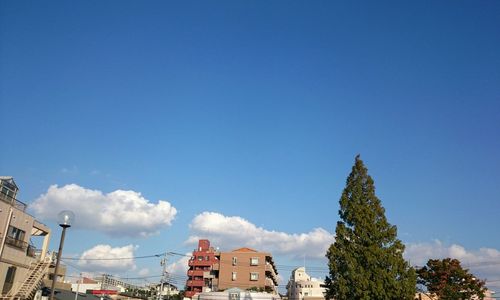 High section of buildings against blue sky