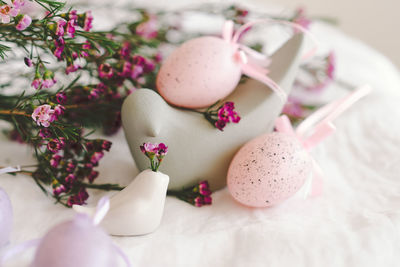 Easter eggs with flowers on white linen fabric.