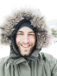 Portrait of smiling young woman in snow